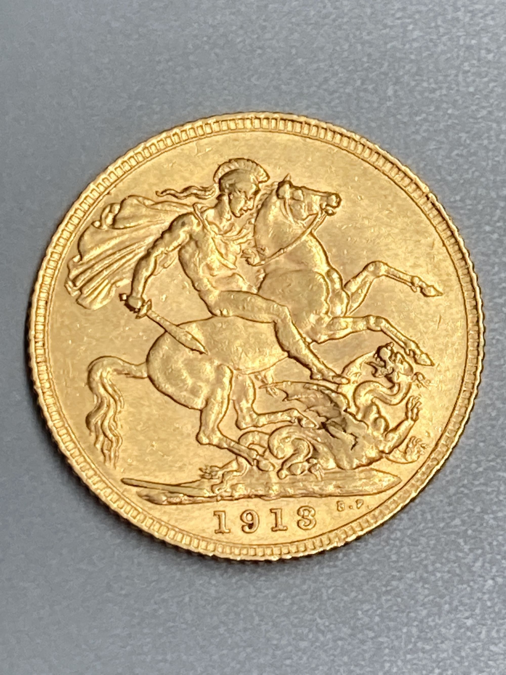 A George V 1913 gold sovereign, GVF.